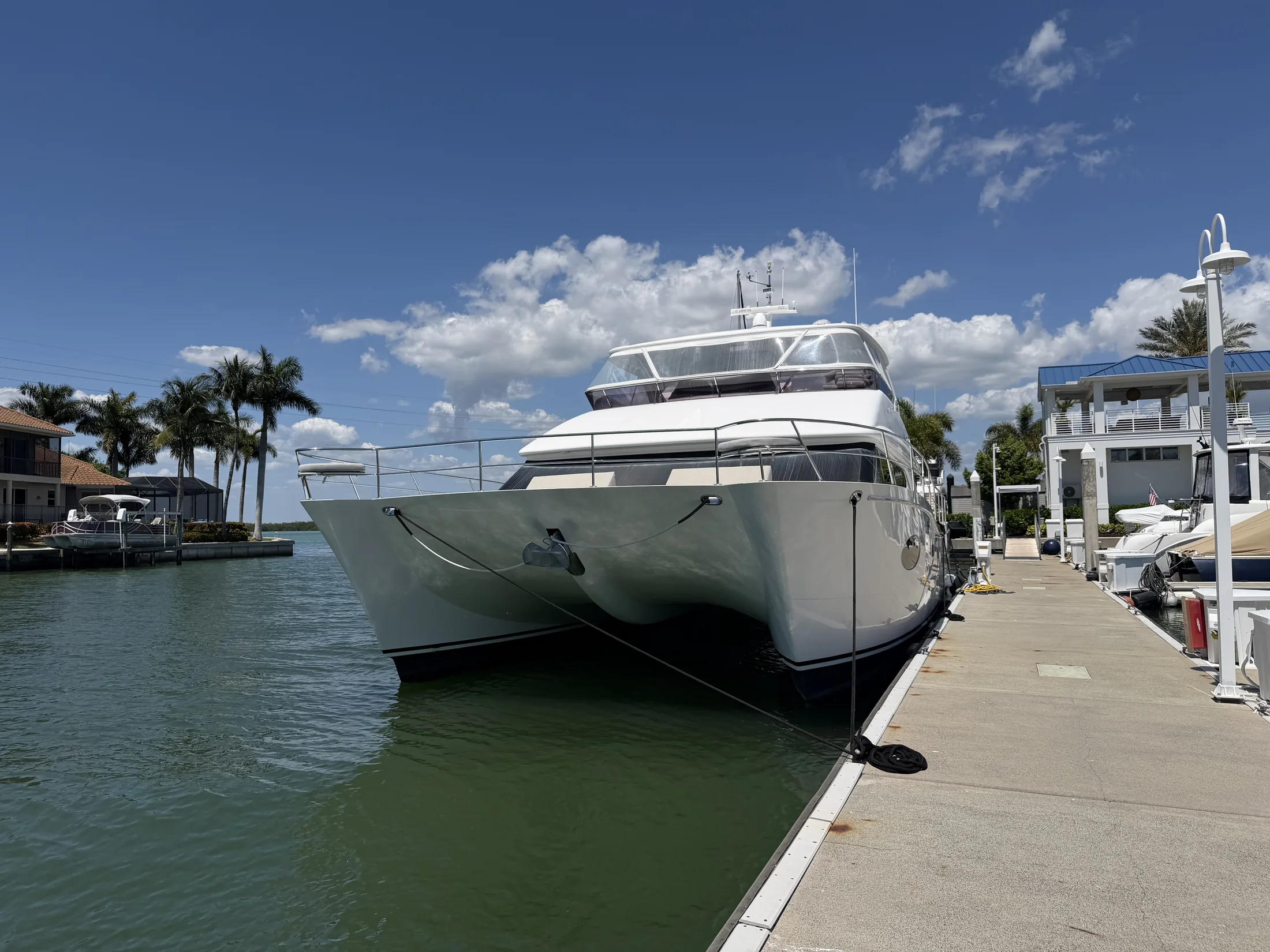 Large power catamaran docked at a marina